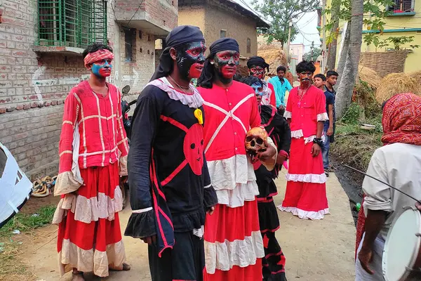 stock image Murshidabad, West Bengal, India - June 14, 2022; a picture of a group of Lord Shiva worshippers, who wear various tattoos on their faces, wear strange clothes, and assume a terrifying form holding human skulls in their hands.