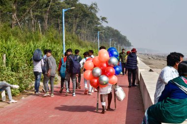 Oceana Beach, West Bengal, India, January 01, 2025, This picture depicts the scenic Oceana Beach, New Digha, in the Bay of Bengal, where tourists and balloon sellers are strolling along the seashore and indulging in their vacation fervor. clipart