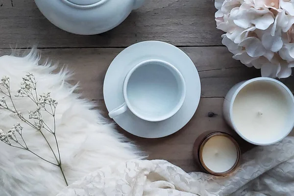 stock image A pretty and feminine flat lay with tea service concept and hydrangeas. Cream colored lace and fur accent for a gorgeous aerial shot.