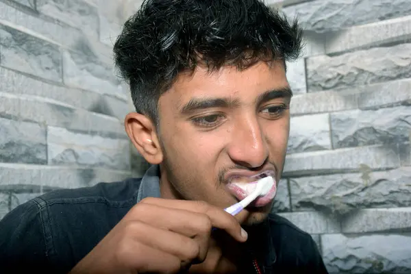 stock image a boy Brushing Teeth In Bathroom ,black shirt