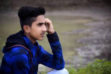 Mavi elbiseli Hintli manken çocuk, yeşillik arka planda..