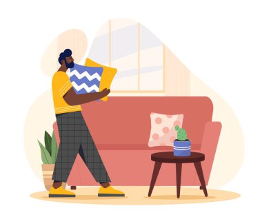 Daire döşeyen bir adam. Genç adam kanepeye yastık koyuyor. Evdeki rahatlık ve rahatlık. Yer değiştirme ya da göç üstüne karakter. Düz vektör çizimi beyaz arkaplanda izole edildi