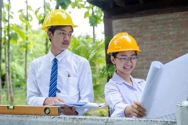Engineer contractor team meeting work safety plan industry project and check design at the construction building site