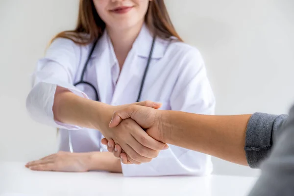 handshake after Doctors advice report health examination results and recommend medication to patients, occupational consultation medical checkup program concept.