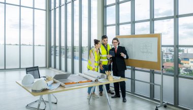 Engineer team is meeting to inspect the construction blueprint drawings, work plan and distribute work before starting the building.