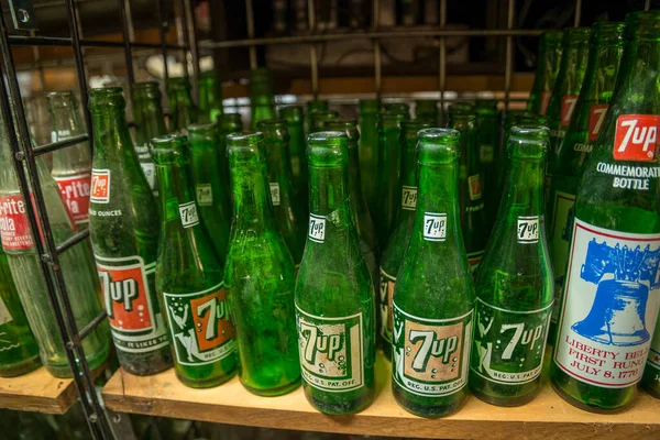 stock image Clarkrange, Tennessee USA - April 08, 2021  Worn and weathered antique 7-up bottles grouped together on a shelf closeup view