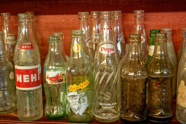 stock image Clarkrange, Tennessee USA - March 25, 2023  A collection of old glass soda bottles of various brands and sizes displayed on a shelf group together