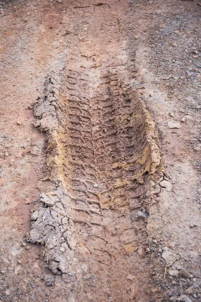 Car tire tracks on mud dirt background.