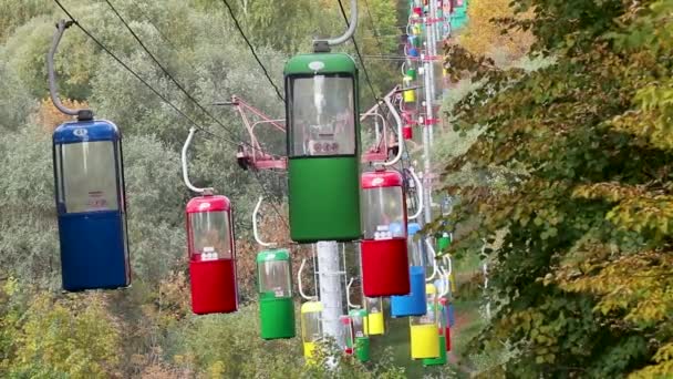 哈尔科夫市游乐园中五彩缤纷的小木屋开着车 光缆运送着秋天五彩缤纷的树木 — 图库视频影像