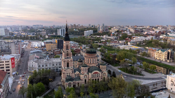 Holy Annunciation Cathedral aerial view with evening sunset scenic cloudscape. Kharkiv city orthodox church in downtown, Ukraine