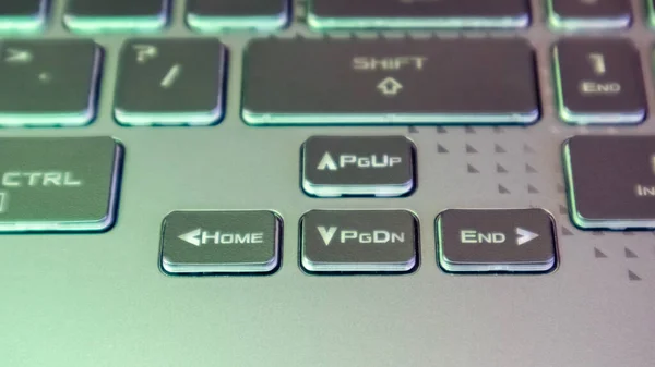 Laptop arrow keys. Gaming powerful grey notebook keyboard close-up. Tech, IT, electronics, computer science background