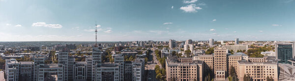 Aerial panoramic view on Derzhprom and Karazin National University buildings on Freedom Square and blue sunny sky in Kharkiv, Ukraine