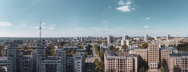 Aerial wide view on Derzhprom and Karazin National University buildings on Freedom Square and blue sunny sky in Kharkiv, Ukraine