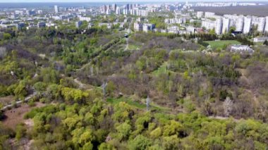 Harkiv Central Şehir Parkı 'ndaki yerleşim bölgesi yakınlarındaki kablo yolunun üzerinde ilerliyorlar. Bahar ağaçları insansız hava aracının yeşillik havadan görüntüsü