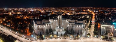 Aerial night panorama with illuminated Karazin University building on Freedom Square in Kharkiv city center, Ukraine clipart