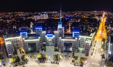 Aerial night view of Derzhprom building with blue lights on Kharkiv city Freedom Square clipart