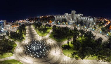 Aerial night Freedom Square wide panorama with fountain and illuminated Karazin University building in Kharkiv city center, Ukraine clipart