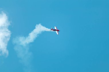 Hafif uçak uçağı Su-31 mavi gökyüzünde yoğunlaşma izleri gösteriyor.