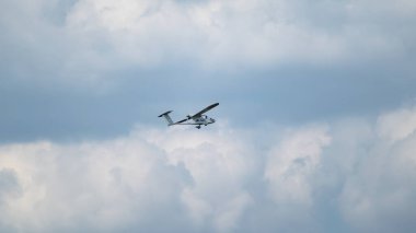 Aeroprakt A-40 Ukrainian tandem aircraft plane flying in cloudy sky on airshow clipart