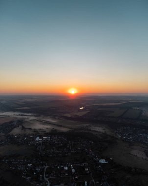 Yazlık tarlaları, küçük köyleri ve gündoğumu manzarası olan bir yer.