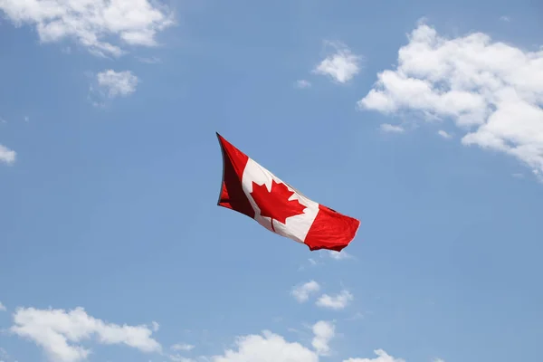 stock image Canadian flag flies in the blue sky, Canada. High quality photo