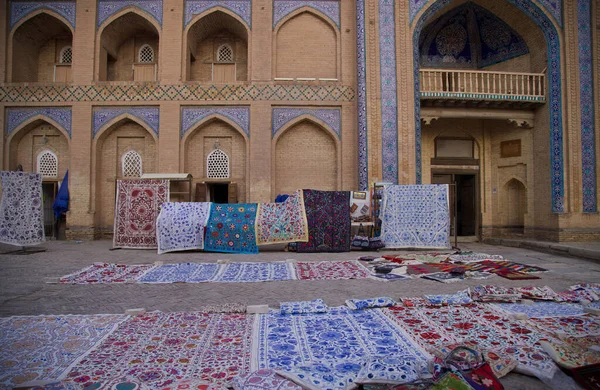 Sale of carpets in front of the Islam Khoja Madrasa in Khiva, Uzbekistan. High quality photo