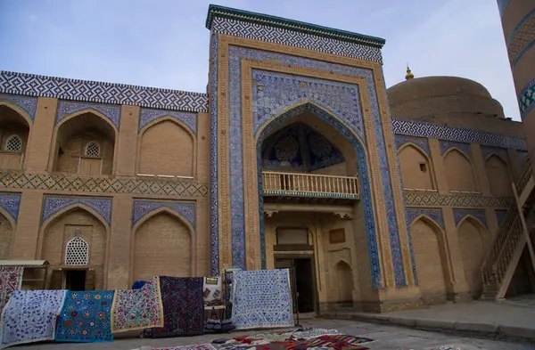 Sale of carpets in front of the Islam Khoja Madrasa in Khiva, Uzbekistan. High quality photo