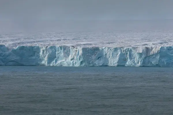 stock image Austofonna glacier with its sheer slopes overlooking the sea, Svalbard Islands. High quality photo