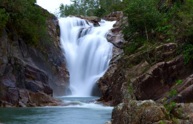 Motion blur of Big Rock Falls in Mountain Pine Ridge Forest Reserve, Belize. High quality photo clipart