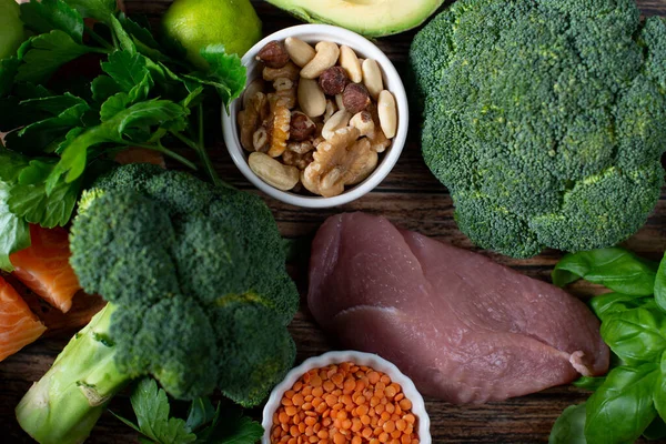A variety of organic products, meat, fish, vegetables. Balanced diet. healthy vegetables, cereals, meat and greens on a gray background.The keto diet.