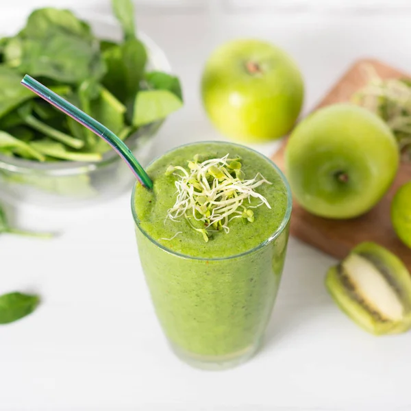 smoothie of micro-green apples cucumber and spinach on a light background. eco organic fresh food detox . ingredients fresh micro-greens .