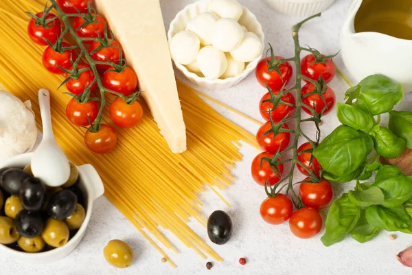 stock image Ingredients of mediterranean cuisine in the form of the Italian flag on a white slate,stone or concrete background.Top view.