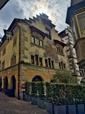 28.07.24.Switzerland. Cozy street in a European town with historic buildings and colorful architecture. The scene features a decorative fountain in the foreground and charming facades of old houses. clipart