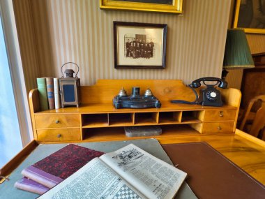 13.07.24 Switzerland. Yüksek tavanlı görkemli bir yemek odası, uzun ve zarif bir masa. Duvarlar portre ve geyik boynuzlarıyla süslenip sofistike ve görkemli bir atmosfer yaratıyor.