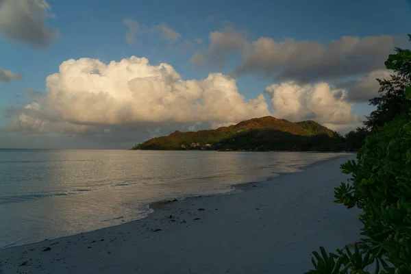View along the long beach of Anse Volbert in the evening on the Seychelles island of Praslin.