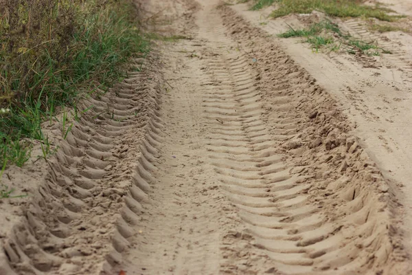 Deep tracks of heavy machinery in the sand