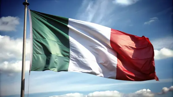 stock image Italian Flag Waving Against a Blue Sky with Clouds