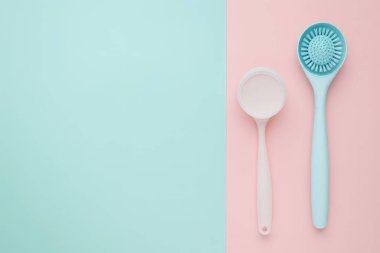 Pastel Cleaning Utensils on a Two Tone Background clipart