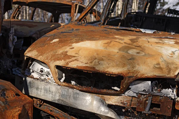 rusty car that burned at a scrapyard