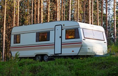 Lycksele, Norrland Sweden - July 24, 2021: large caravan parked in the forest