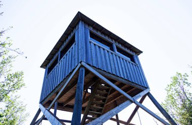 wooden tower used for bird watching, seen from the ground