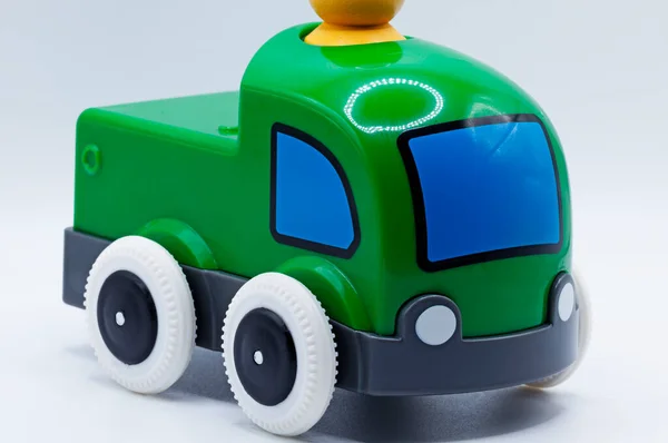 a green toy truck on a white background