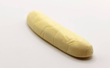 A long, cream-colored marshmallow candy with banana flavoring, showing a soft, pillowy texture. clipart