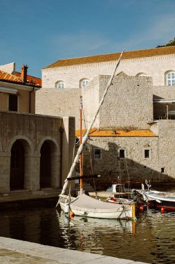 Amazing view of Dubrovnik and the boat in a marina on a sunny day. Travel destination in Croatia.