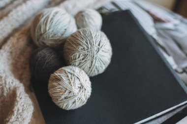 Balls of wool yarn for hand knitting on a notebook. Concept for handmade. Place for text.