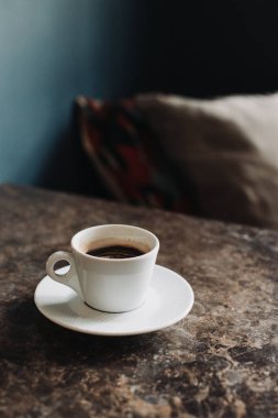 Cup of black coffee on a table in a cafe. Selective focus. Place for text.