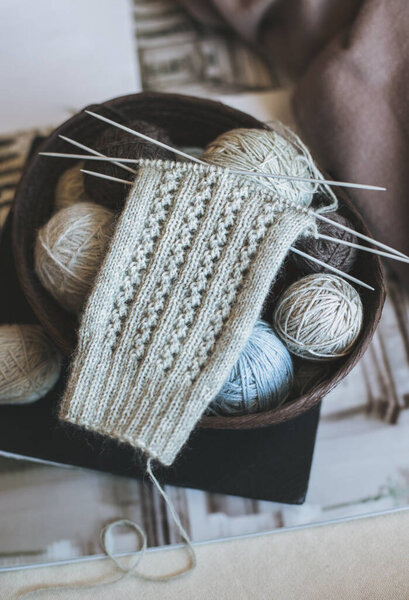 Рука вязаные носки с иголками и пряжи мяч в корзине. Мбаппе для ручной работы и гипермедленной жизни.