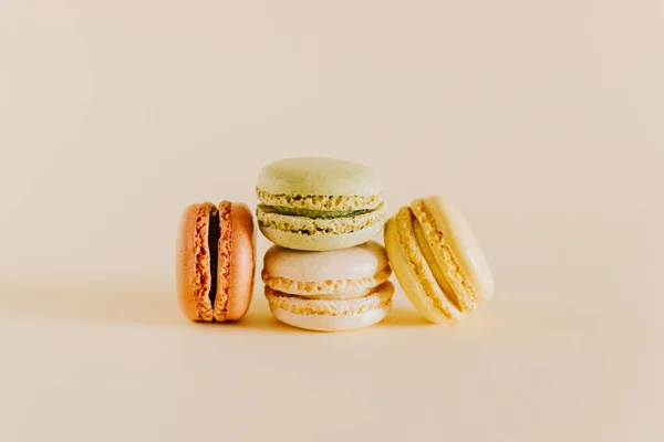 stock image Tasty french macarons on a peach pastel background. Place for text.