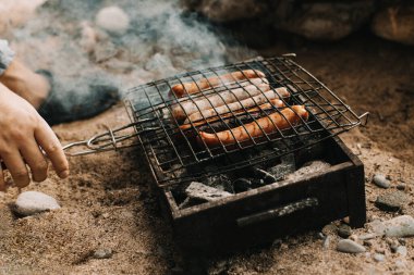 Delicious grilled sausage on a barbecue. Picnic menu. Selective focus.