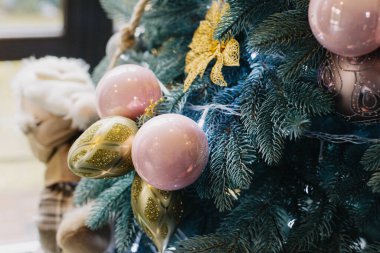 Spruce branches with Christmas ornaments and lights. Selective focus.